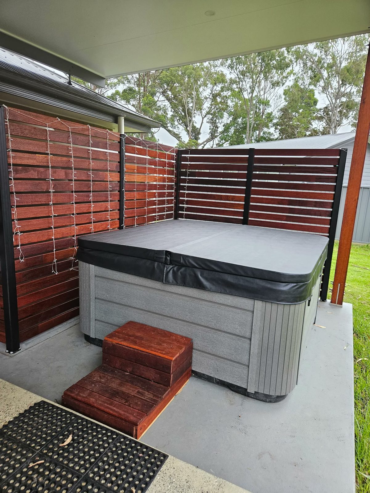 Spa against timber privacy screens with fairy lights